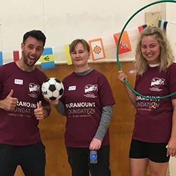 Volunteers and children doing sports and fitness exercise
