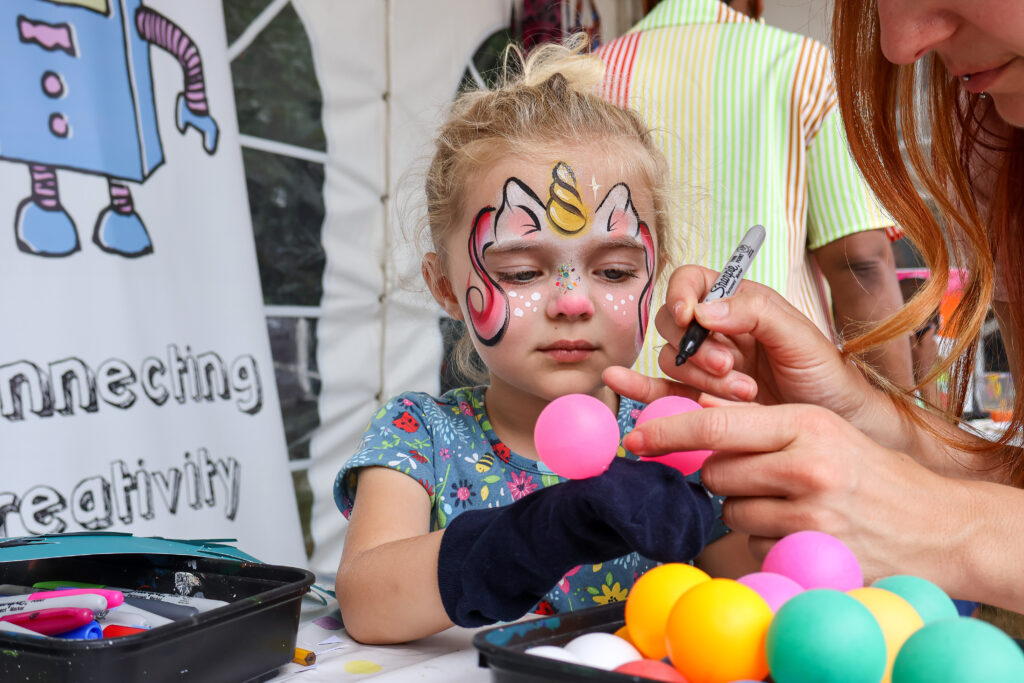 Sticks N Stones festival girl getting face painted