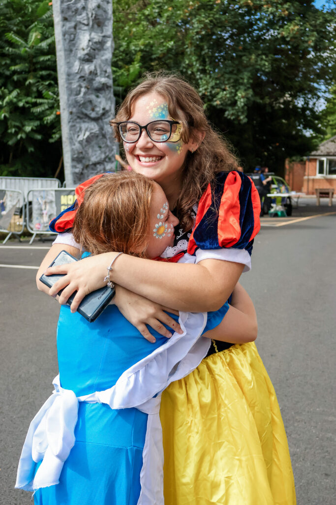 Children hugging a Disney princess at the Sticks N Stones Festival in Medway Kent