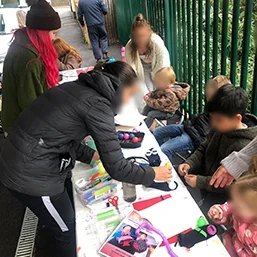 children and adults doing arts and crafts